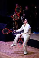 This person is juggling tennis rackets!